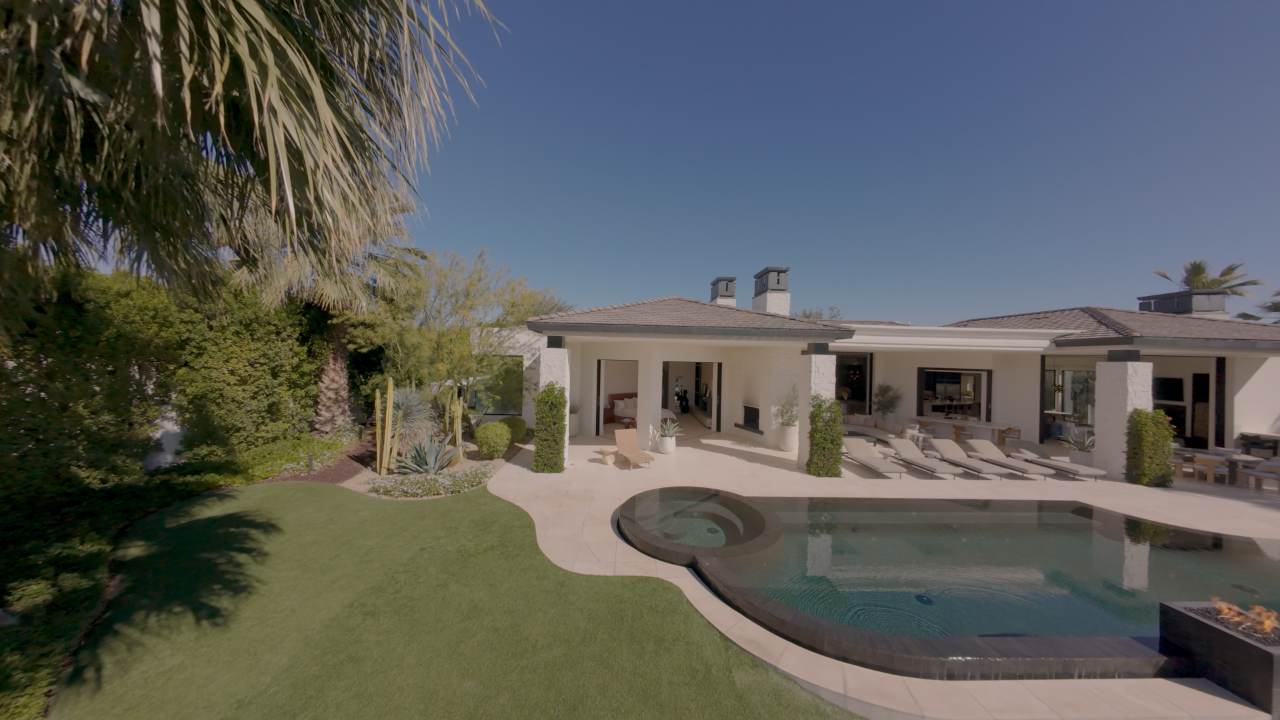 Pool, spa and the rear glass elevation of the house