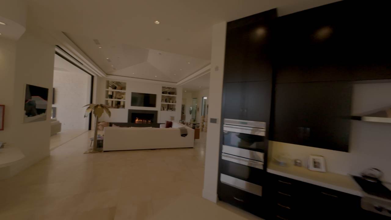 Kitchen with full-height dark cabinetry behind a long island